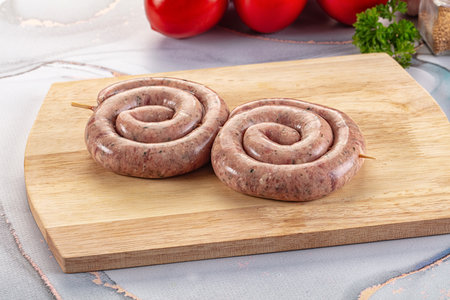 Raw meat pork and beef swirl sausages for grillの写真素材