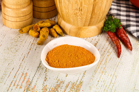 Tumeric curcuma powder for culinary in the bowlの写真素材