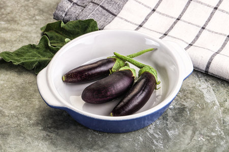Small few baby eggplant over board for cookingの写真素材