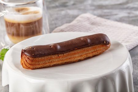 Gourmet chocolate eclair with brown icing
