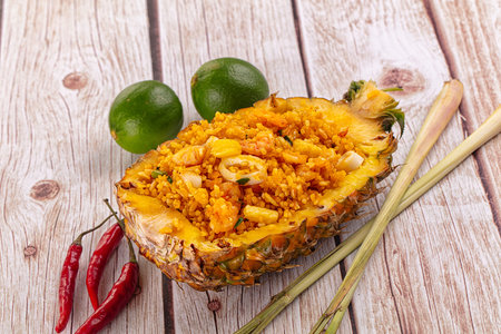 Seafood fried rice in pineapple half with prawn and squidの写真素材