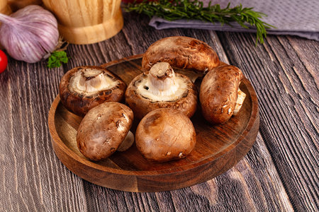 Raw brown champignon heap in the bowl for cookingの写真素材