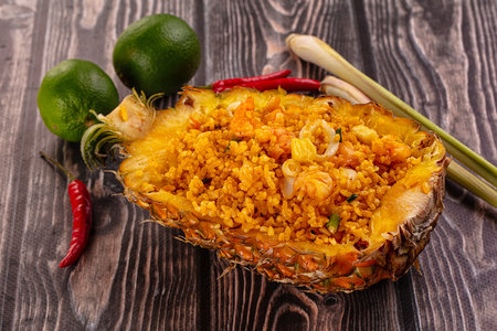 Seafood fried rice in pineapple half with prawn and squidの写真素材