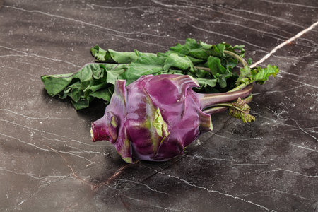 Ripe fresh violet kohlrabi cabbage with leaves