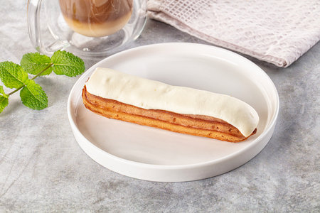 White delicous vanilla eclair with icing dessert