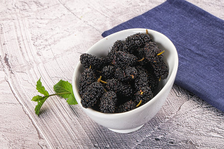 Juicy sweet black mulberry in the bowl