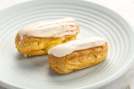 Delicious tasty eclair with ising and cream