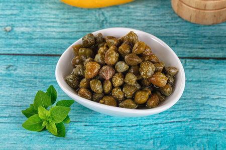 Pickled canned capers snack antipasti in the bowl