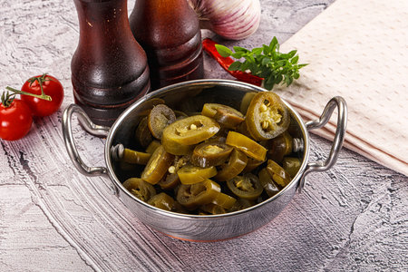Sliced pickled jalapeno spicy pepper for cookingの写真素材
