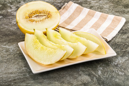Sweet juicy ripe melon slices in the plateの写真素材