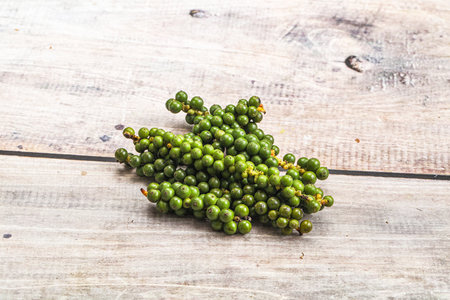 Green pepper corn on the branch heapの写真素材