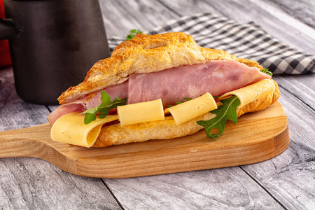 Fresh croissant with ham and cheese for breakfastの写真素材