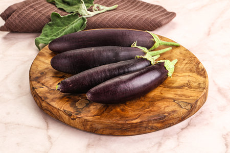 Small few baby eggplant over board for cookingの写真素材