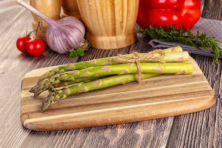 Raw green asparagus heap over boardの写真素材