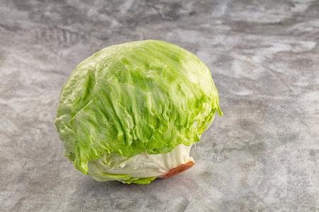 Raw fresh greeniceberg salad over backgroundの写真素材