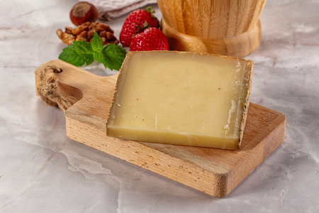 Gourmet hard aged yellow cheese pieceの写真素材