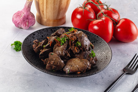 Roasted chicken liver with green onion and spicesの写真素材