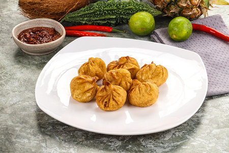 Fried dumplings stuffed with minced pork served with chili sauceの写真素材