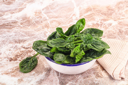 Fresh green spinach leaves heap in the bowl