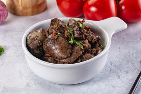 Roasted chicken liver with green onion and spicesの写真素材