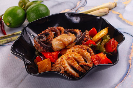 Gourmet grilled octopus with vegetables and sauceの写真素材