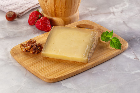 Gourmet hard aged yellow cheese pieceの写真素材