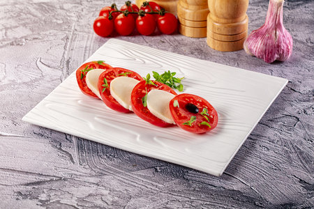 Italian caprese salad with mozzarella cheese, tomato and basilの写真素材