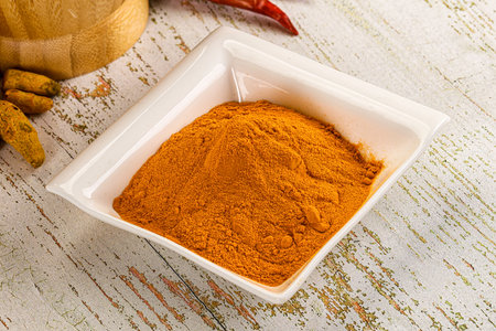 Tumeric curcuma powder for culinary in the bowl