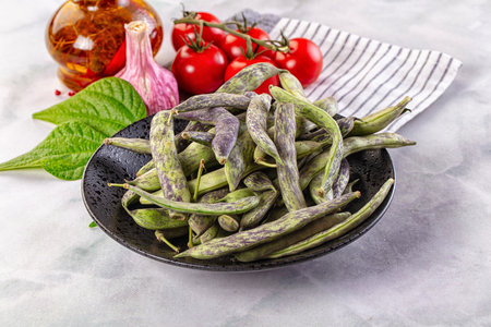 Raw green bean strips heap in the bowl
