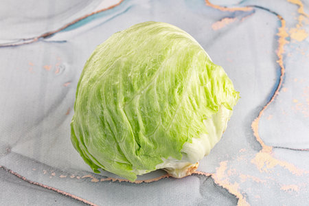Raw fresh greeniceberg salad over background