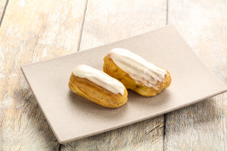 Delicious tasty eclair with ising and cream
