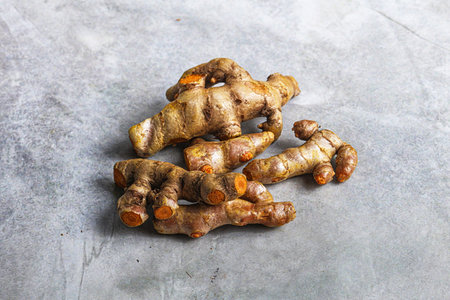 Fresh young Tumeric root heap for cookingの写真素材