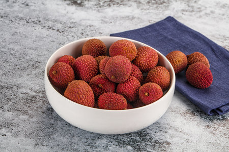 Sweet juicy tropical fruit lychee heap in the bowlの写真素材