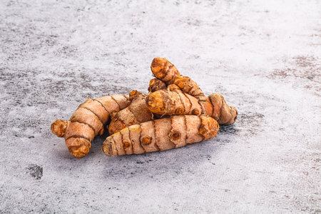 Fresh raw asian tumeric roots heap