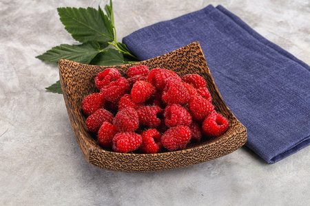 Ripe sweet and juicy organic raspberry in the bowl