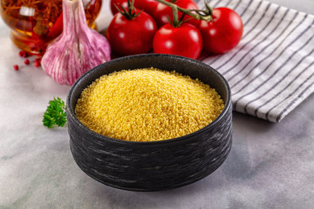 Vegan cuisine - raw dry couscous in the bowl