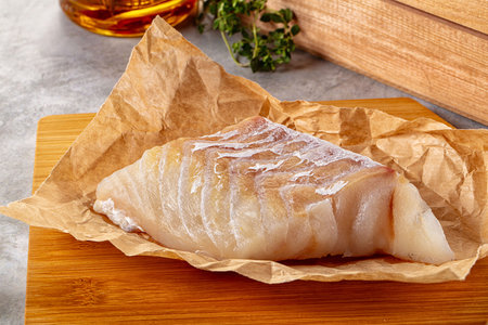 Raw code fish fillet for cooking over board