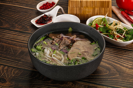 Vietnamese Pho Bo soup with beef, noodles, cilantro and spices
