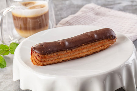 Gourmet chocolate eclair with brown icing