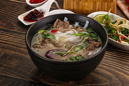 Vietnamese Pho Bo soup with beef, noodles, cilantro and spices