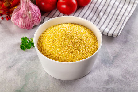 Vegan cuisine - raw dry couscous in the bowl