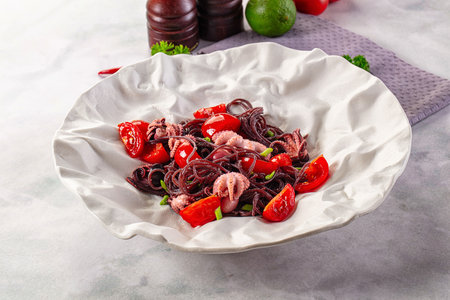 Gourmet black spaghetti with octopus and tomatoの写真素材
