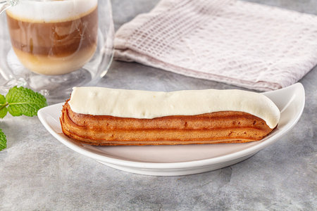 White delicous vanilla eclair with icing dessert