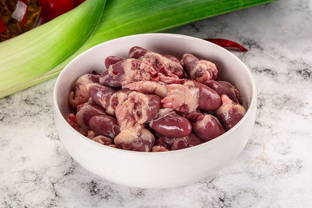 Raw chicken hearts in the bowl for cookingの写真素材