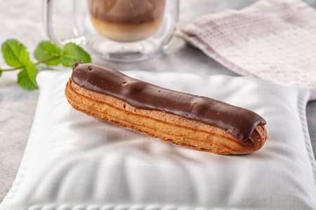 Gourmet chocolate eclair with brown icing
