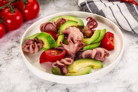 Salad with baby octopus, tomato and avocadoの写真素材