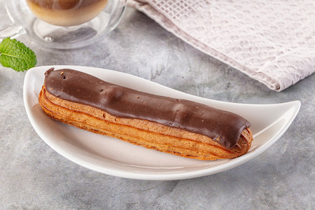 Gourmet chocolate eclair with brown icing