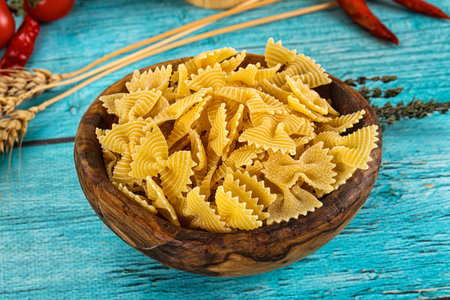 Raw dry farfalle for cooking in the bowl