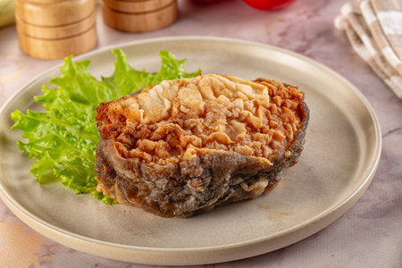 Roasted cod fish fillet piece in the plate