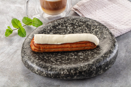 White delicious vanilla eclair with icing dessert